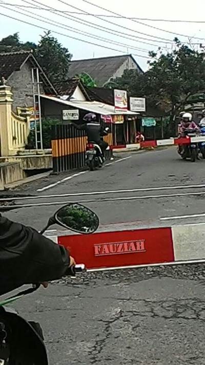 pengendara honda beat terlalu di depan lewati palang kereta api