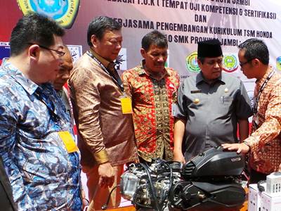 (ke2 kanan) Gubernur Provinsi Jambi, Drs. H. Hasan Basri Agus, MBA mendapat penjelasan dari (kanan) Deputy Head of Corporate Communication AHM, Ahmad Muhibbuddin mengenai mesin sepeda motor Honda berteknologi eSP yang didonasikan pada acara peresmian Tempat Uji Kompetensi - Kurikulum Teknik Sepeda Motor (TUK-KTSM) Honda di SMK Negeri 3, Beliung, Kota Baru, Jambi (5/5). KTSM Honda dikembangkan AHM bekerjasama dengan Kementerian Pendidikan dan Kebudayaan Nasional sejak tahun 2010. Sampai saat ini, AHM telah berhasil menggandeng 320 SMK untuk turut terlibat dalam program ini.